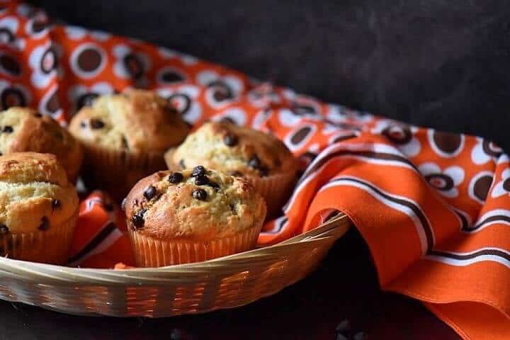 A basket of chocolate chip muffins.