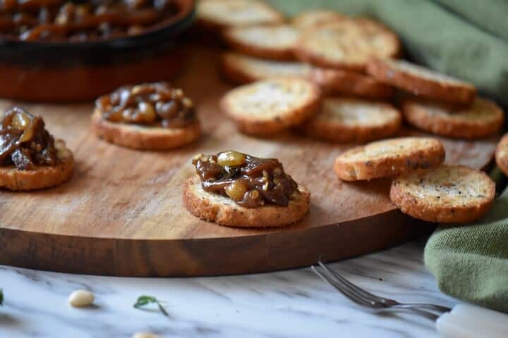 Eggplant caponata on a slice of crispy baguette.