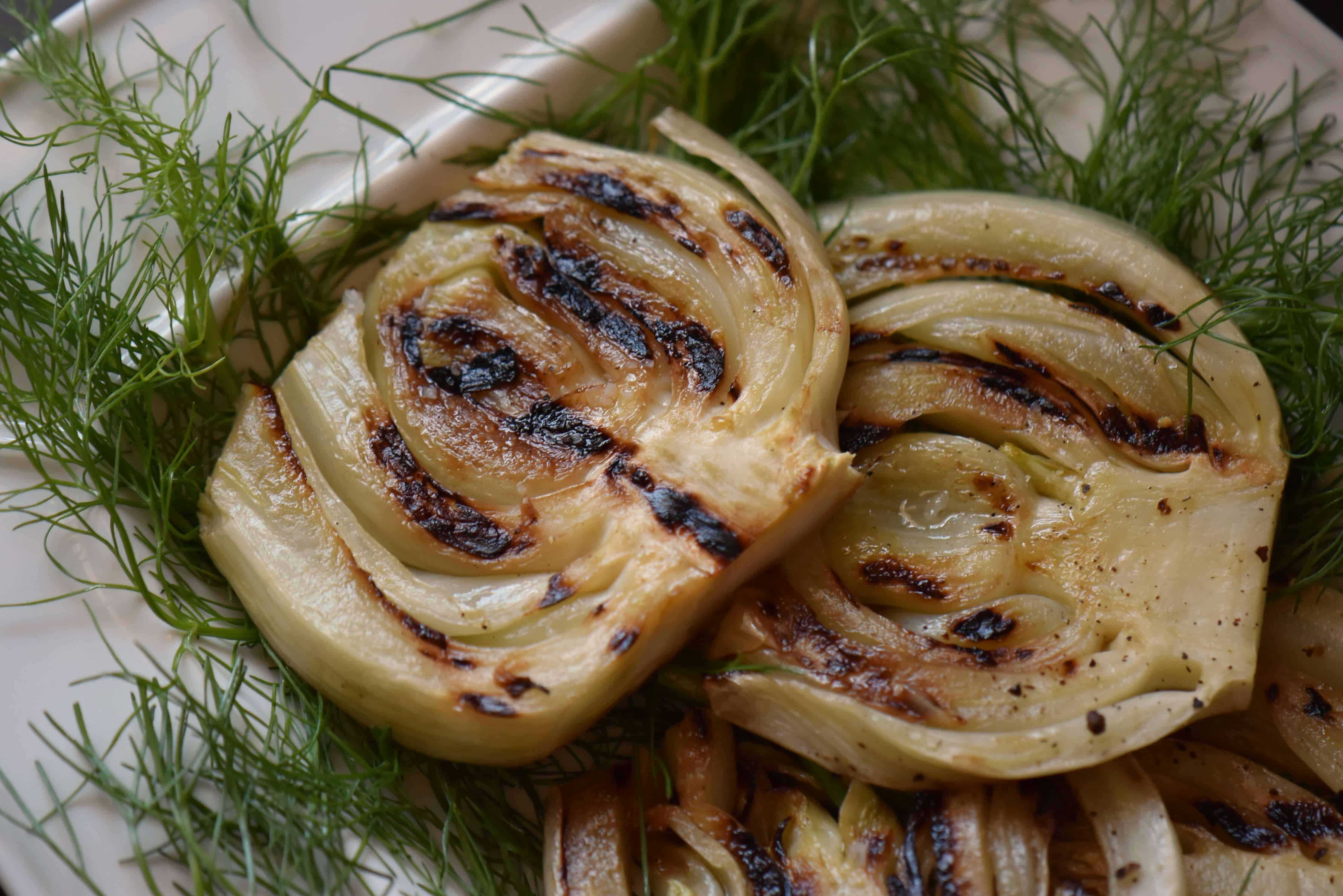 A close up of grilled fennel with barbecue markings.