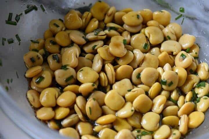 Lupini beans and a zesty vinaigrette in a salad bowl.