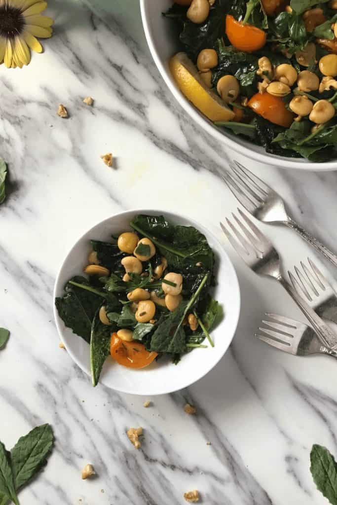 An overhead shot of a lupini beans salad in a white bowl.