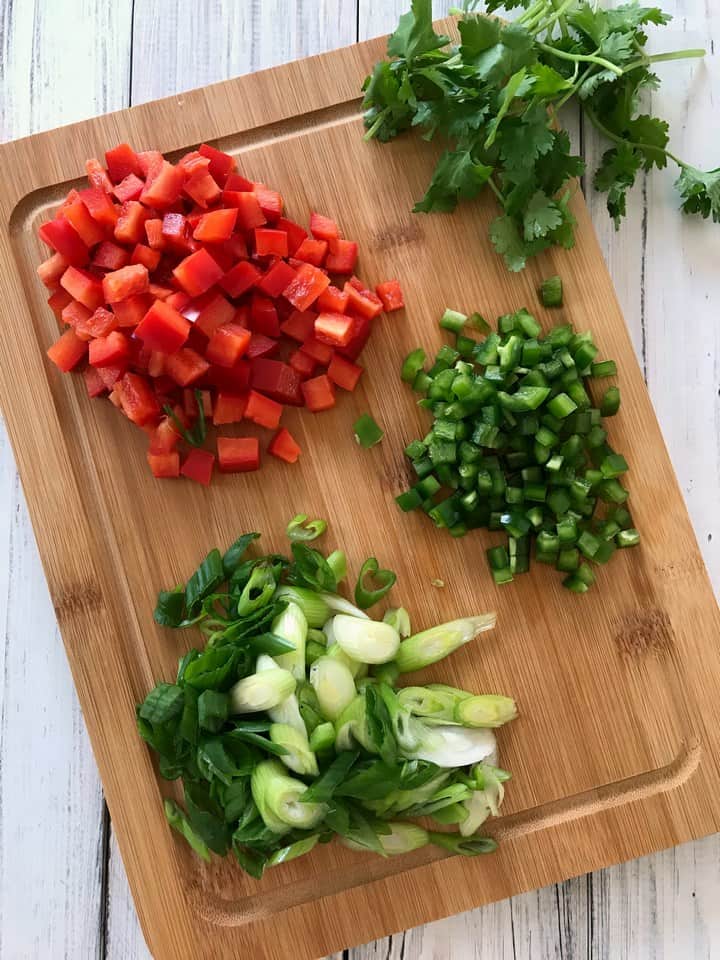 Some of the ingredients used to make the corn salad are: red pepper, jalapeno, scallions and coriander.