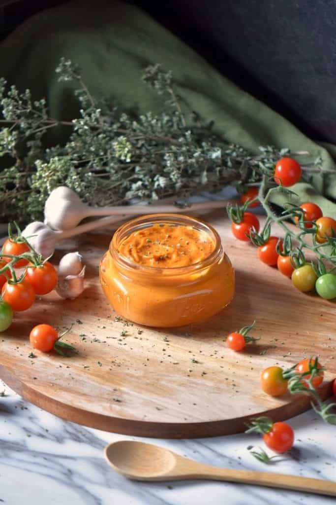 Roasted Cherry Tomato Sauce on a wooden round board.