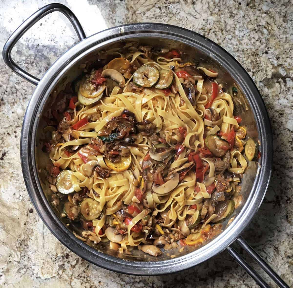 The pasta is now added to the pan of roasted vegetables.