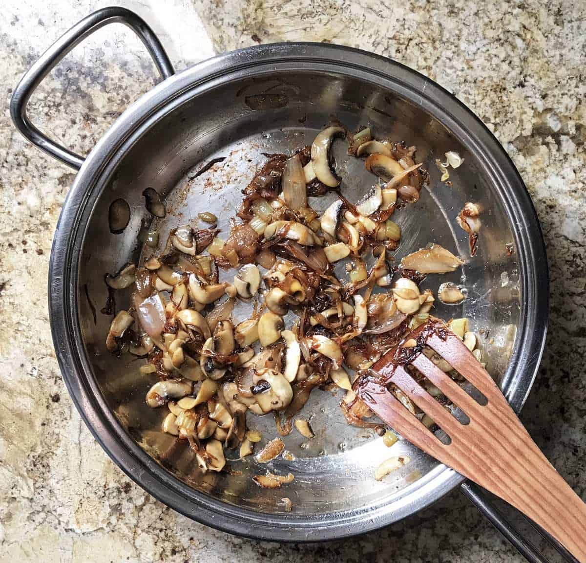 A prep shot of the shallots and mushrooms being sauteed.