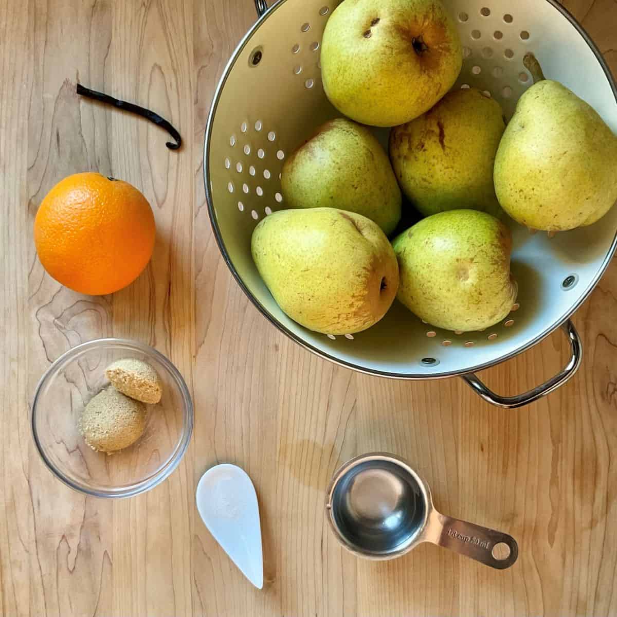 Pear butter ingredients on a wooden table.