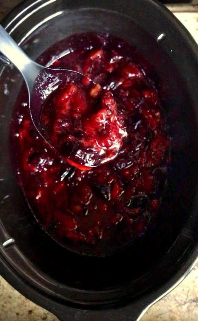 The texture of the plums is shown after an initial cooking period in a slow cooker.