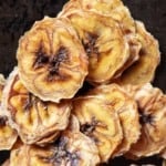 Thinly sliced banana chips piled up high.