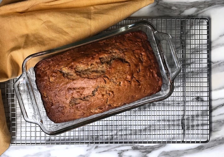 An overhead shot of the banana bread cooling off on a rack.