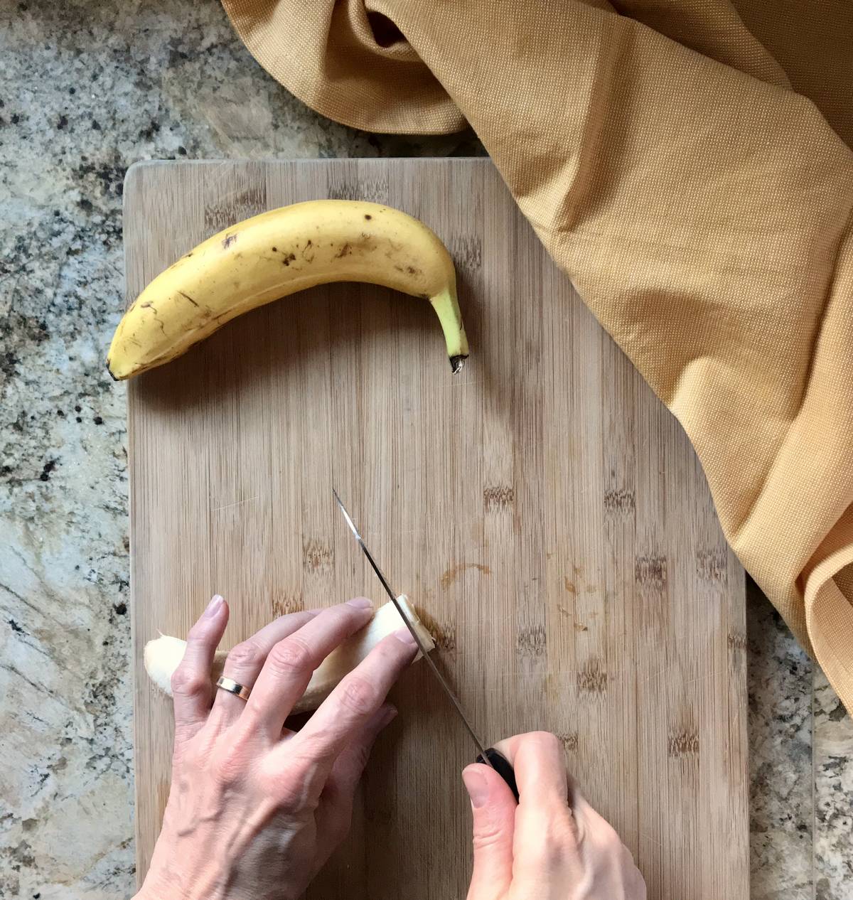 A banana in the process of being sliced.