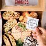 Traditional Italian cookies like pizzelle and biscotti in a cookie box.