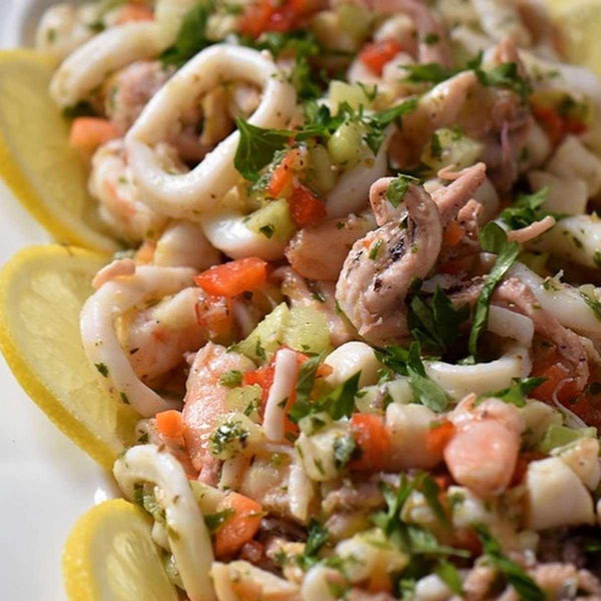 The calamari rings are spotted in this Italian Christmas Eve appetizer, seafood salad.