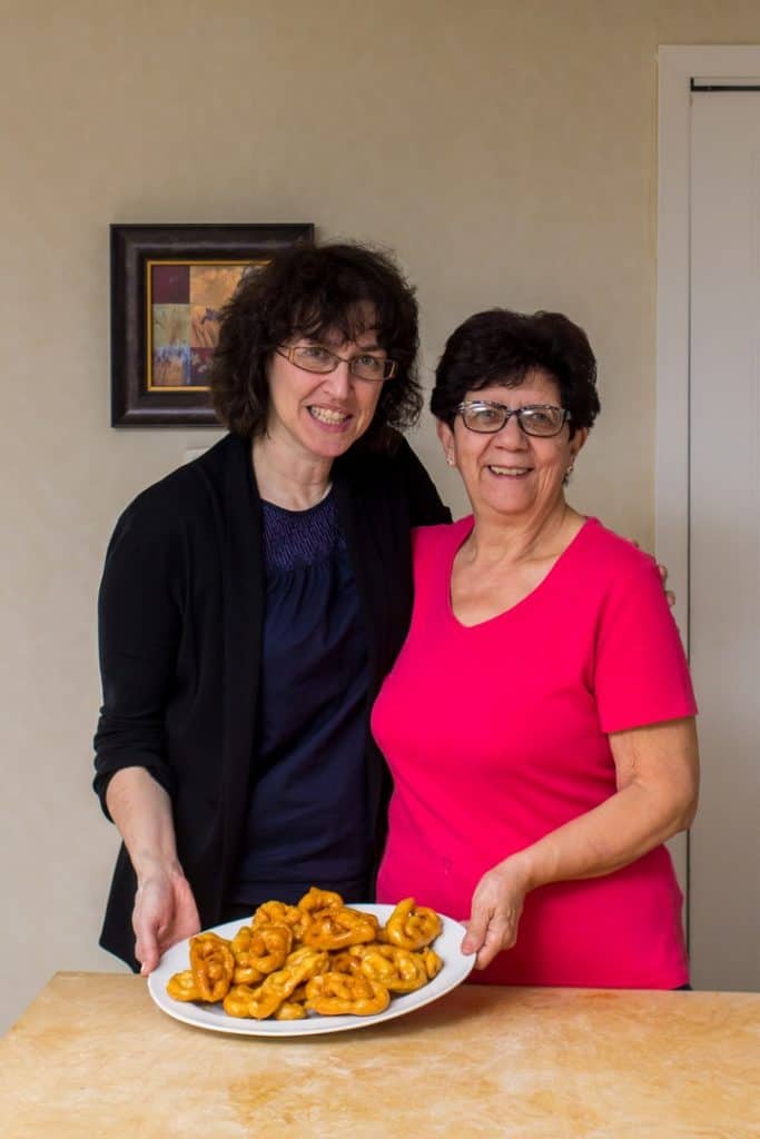 A picture of Maria (from She Loves Biscotti) with her friend Maria and a platter of freshly made Caragnoli. 