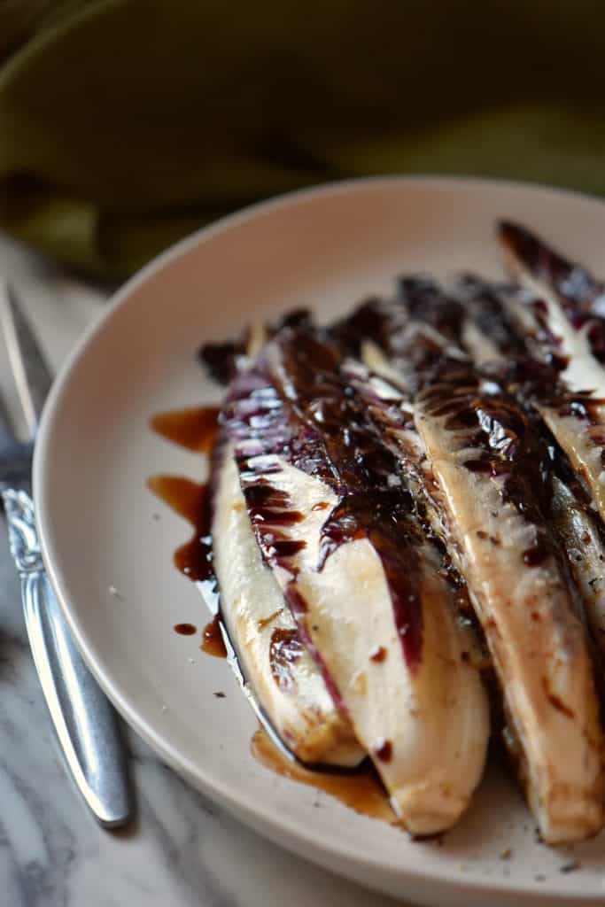 Grilled radicchio sprinkled with salt and pepper and drizzled with balsamic vinegar.