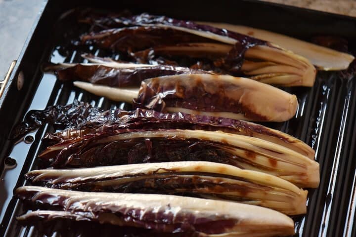 Radicchio sections in the process of being grilled.