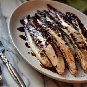Grilled radicchio sprinkled with salt and pepper and drizzled with balsamic vinegar.