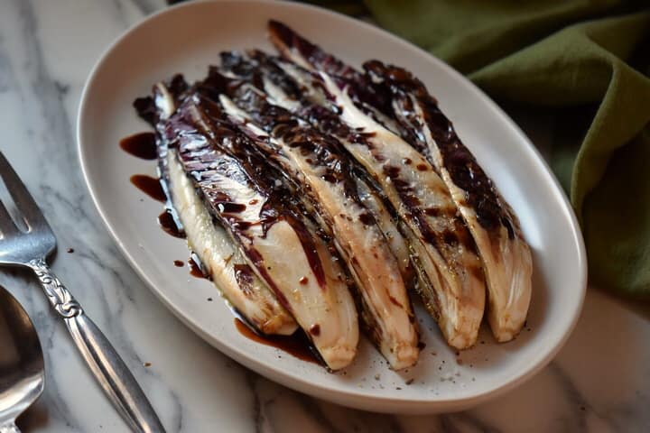 An overhead shot of grilled radicchio on a serving platter.