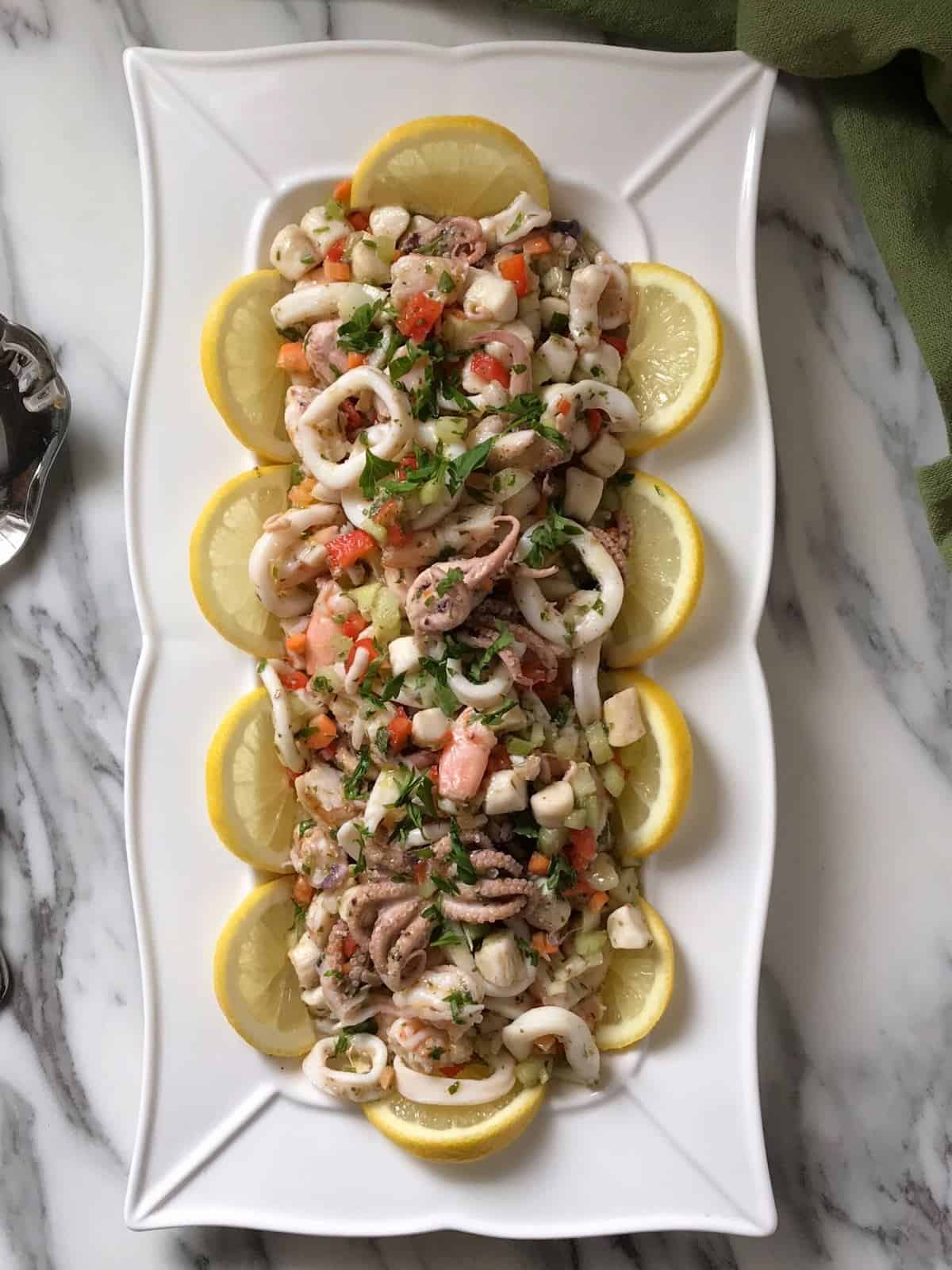 The seafood salad is served in a white dish.