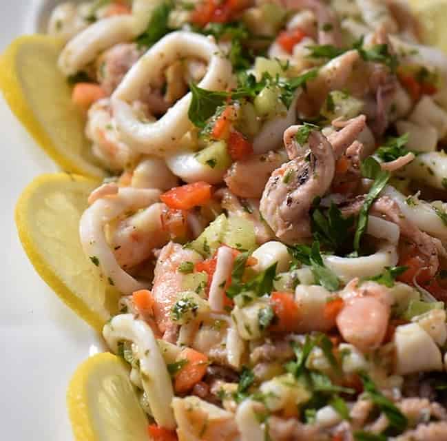 A close up of the seafood salad consisting of calamari, shrimp, octopus and scallops.