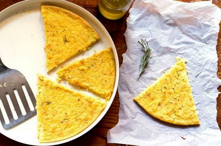 An overhead shot of Cecina flatbread in an oval dish.