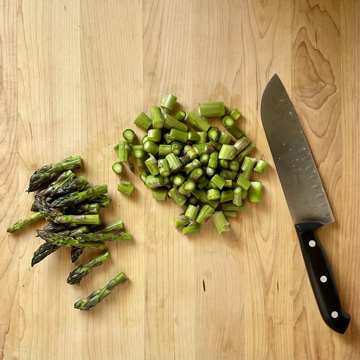 Chopped asparagus on a cutting board.