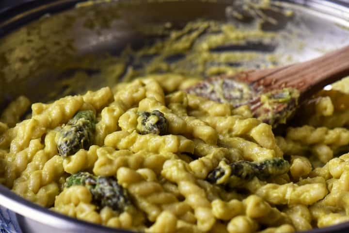 A pot of cheesy, creamy pasta with asparagus.