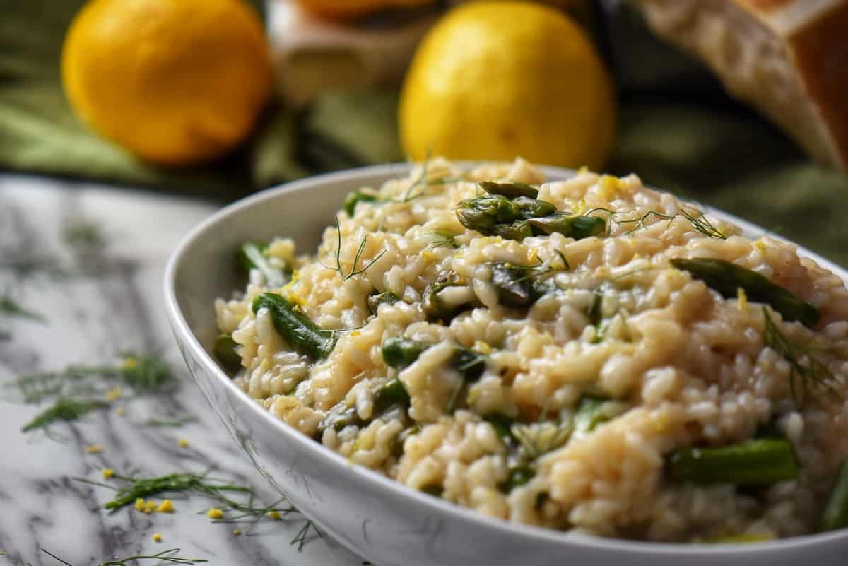A large white bowl of Italian Asparagus Risotto, the perfect spring recipe.