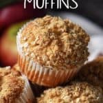 Grated apple muffins with streusal topping piled high on a wicker basket.