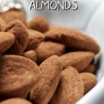Cocoa dusted almonds in a white serving bowl.