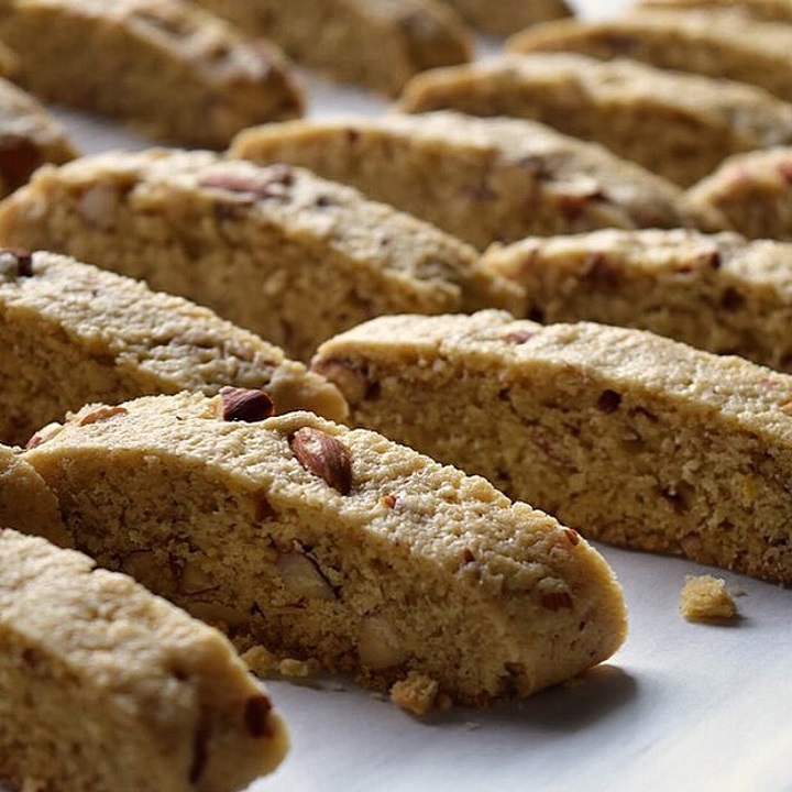 Sliced almond biscotti on a cookie sheet.