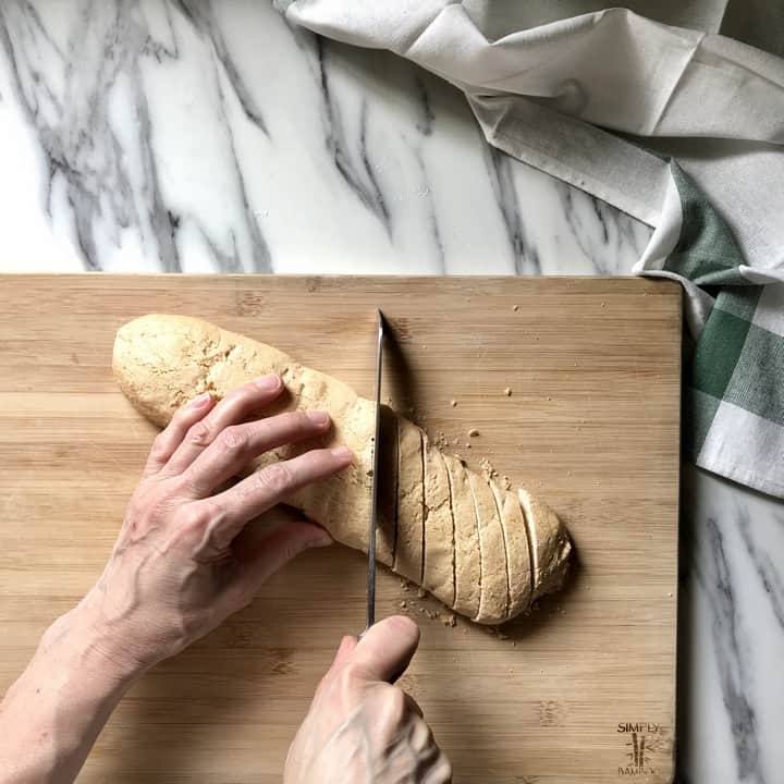 A serrated knife is used to slice the biscotti log.