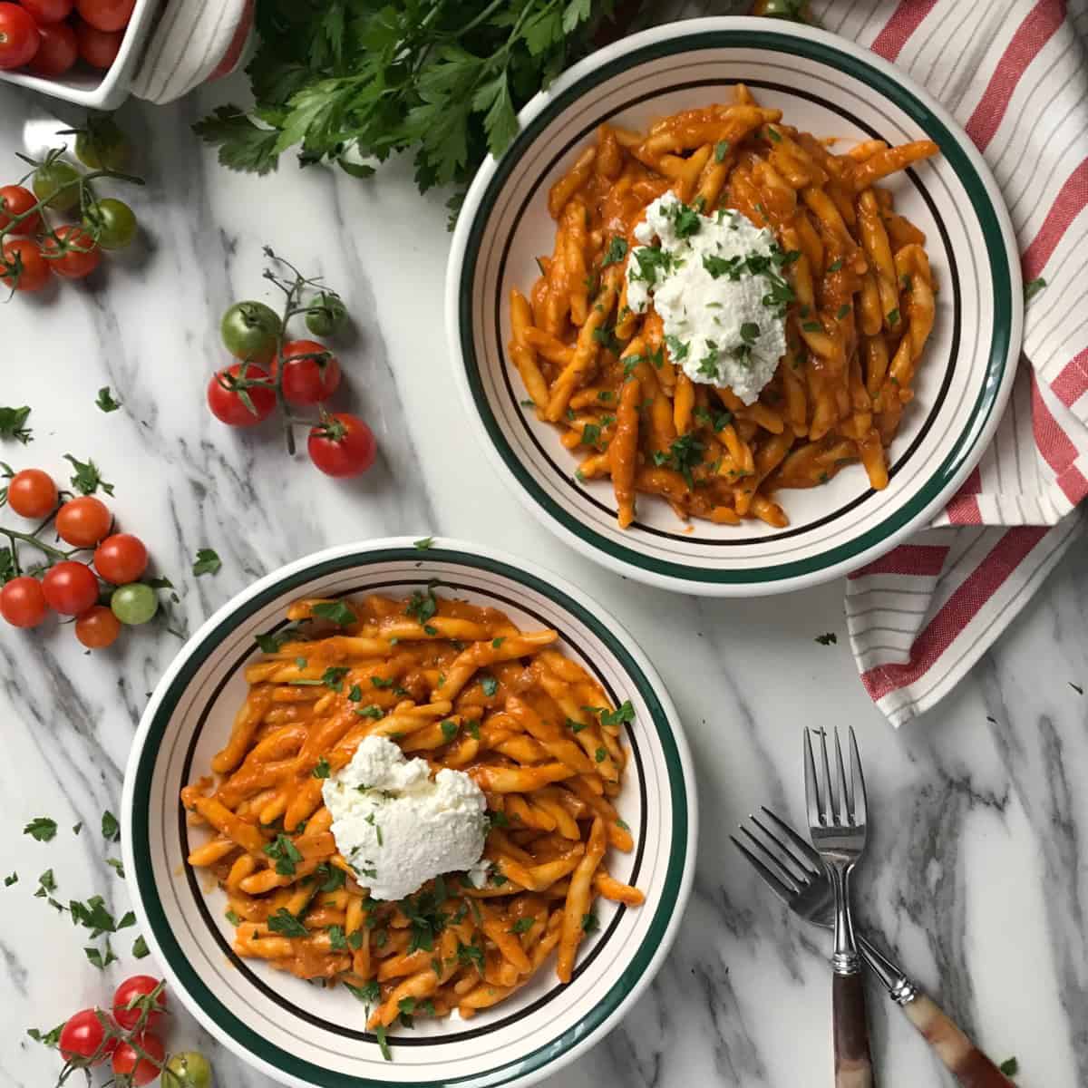 Pasta combined with roasted cherry tomato sauce and a dollop of ricotta.