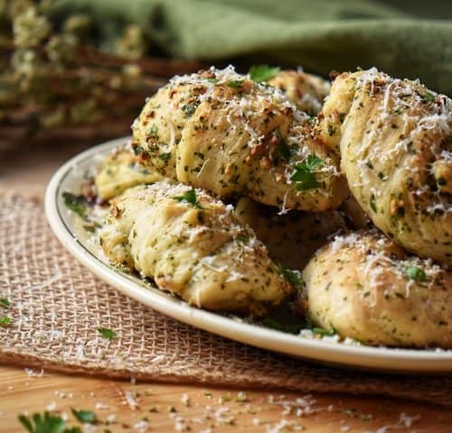 Garlic knots garnished with grated cheese ready to be served.