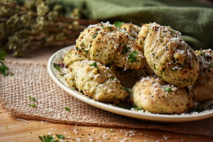 Garlic knots garnished with grated cheese ready to be served.