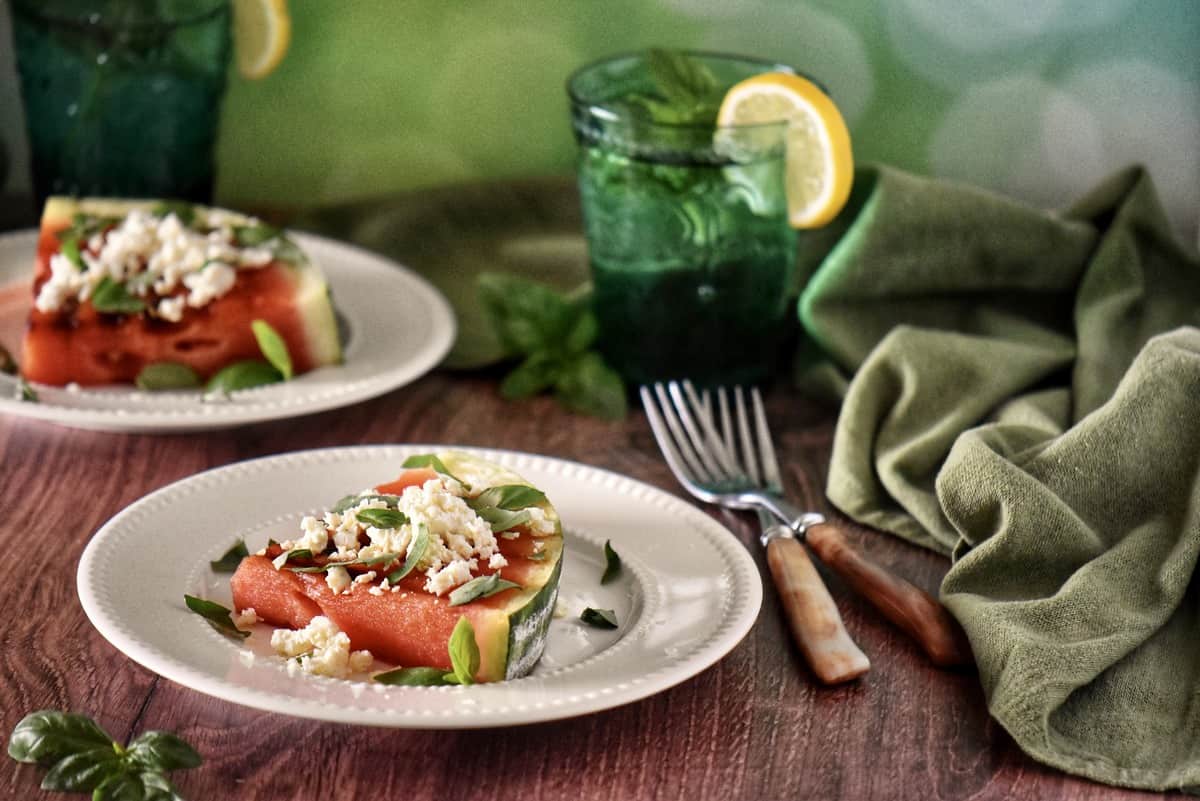 Grilled watermelon on a white plate.