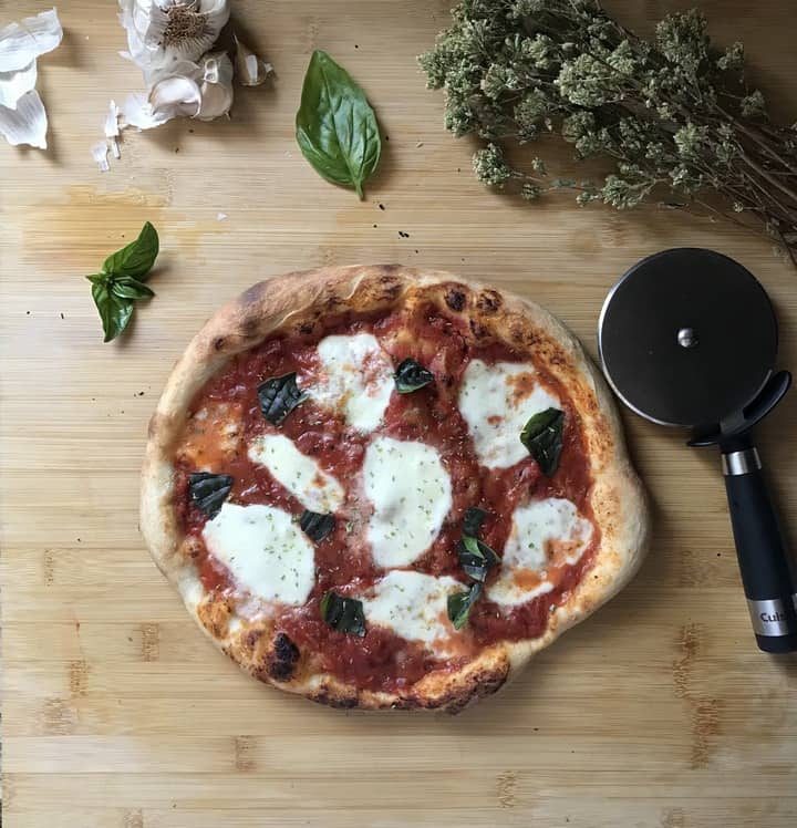 A freshly baked cheese and tomato pizza.