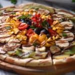 A savory pizza topped with chocolate spread and seasonal fruits.