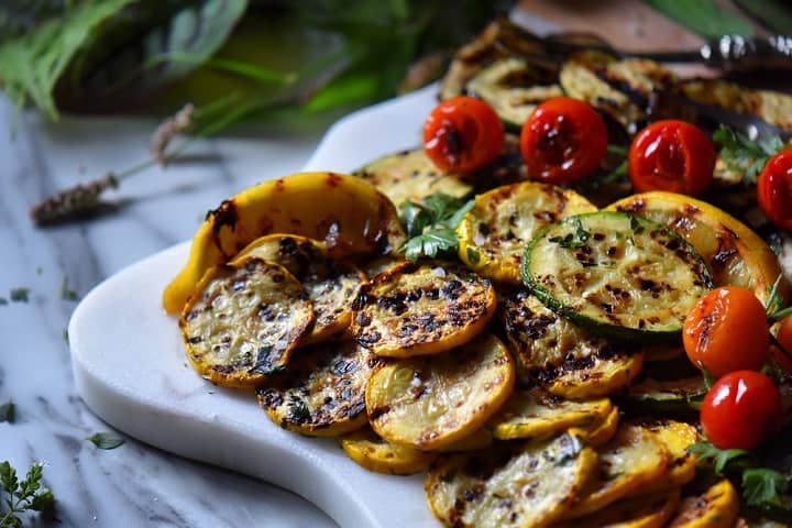 A few grilled vegetables on a white serving platter.