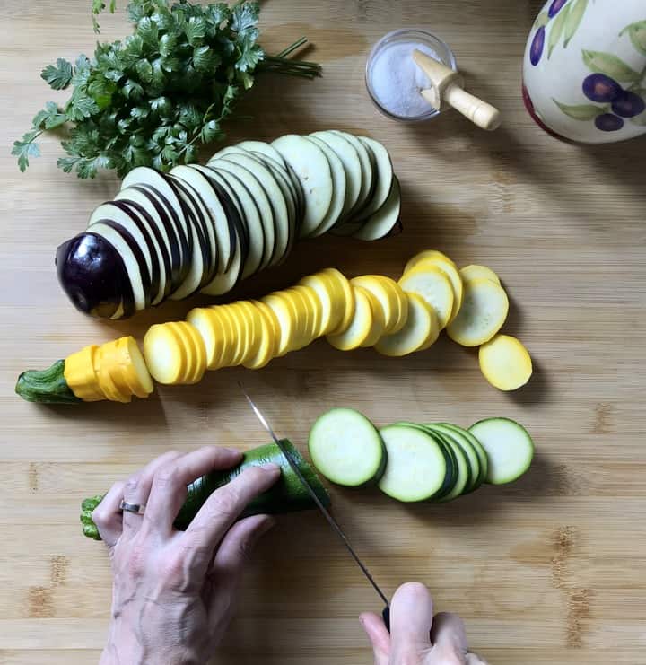 Sliced zucchini and eggplant on a wooden board soon to be transformed into the best grilled vegetables.