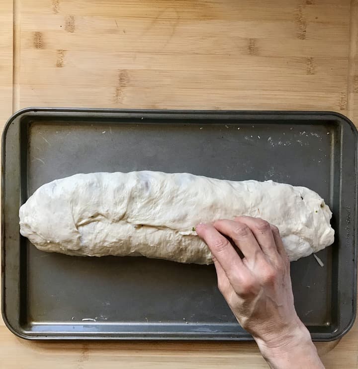 The pizza dough is rolled together just like a jelly roll.