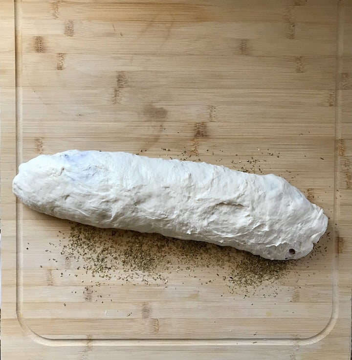 The sausage bread is rolled in dried oregano.