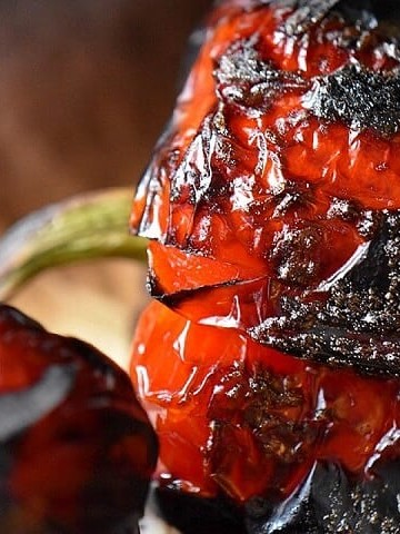 A close up of the charred skin of a roasted red pepper.