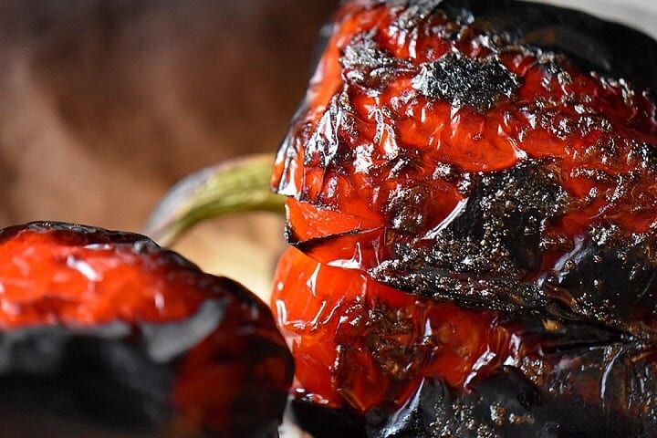 A close up of the charred skin of a roasted red pepper.