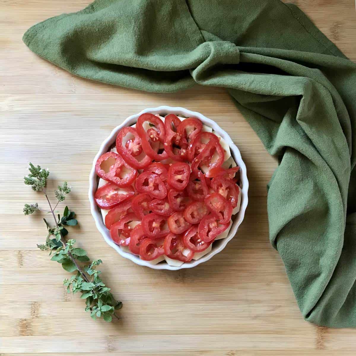 The final layer of sliced Roma tomatoes for the Mediterranean Vegetable Bake. 