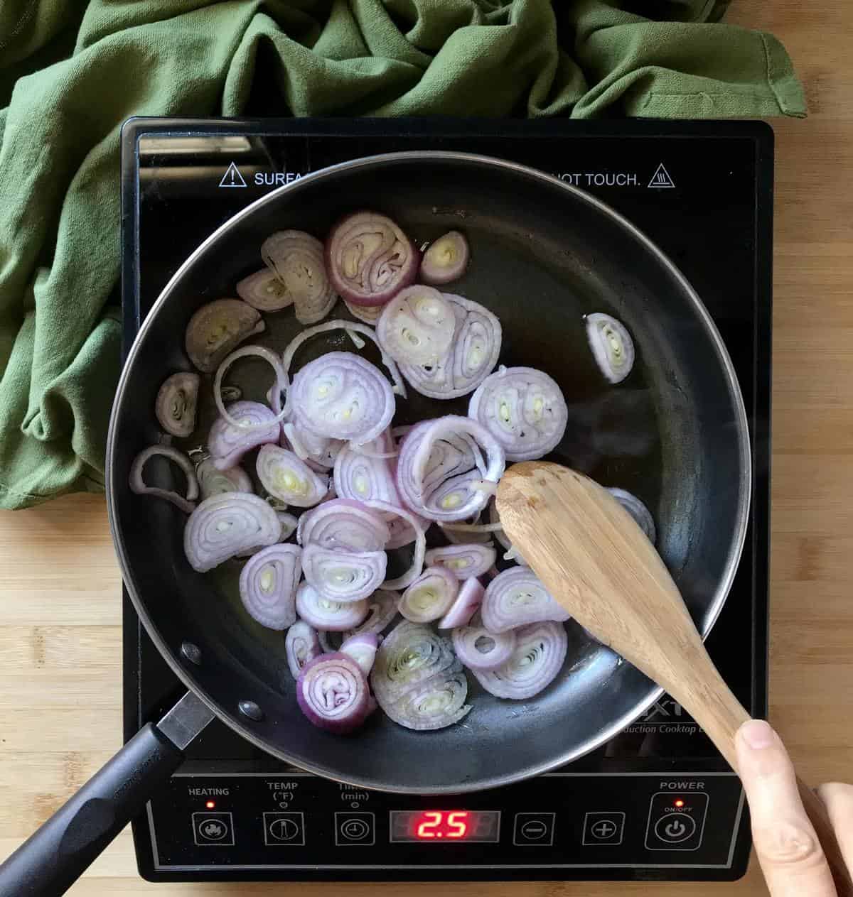 Shallots are in the process of being sauteed.