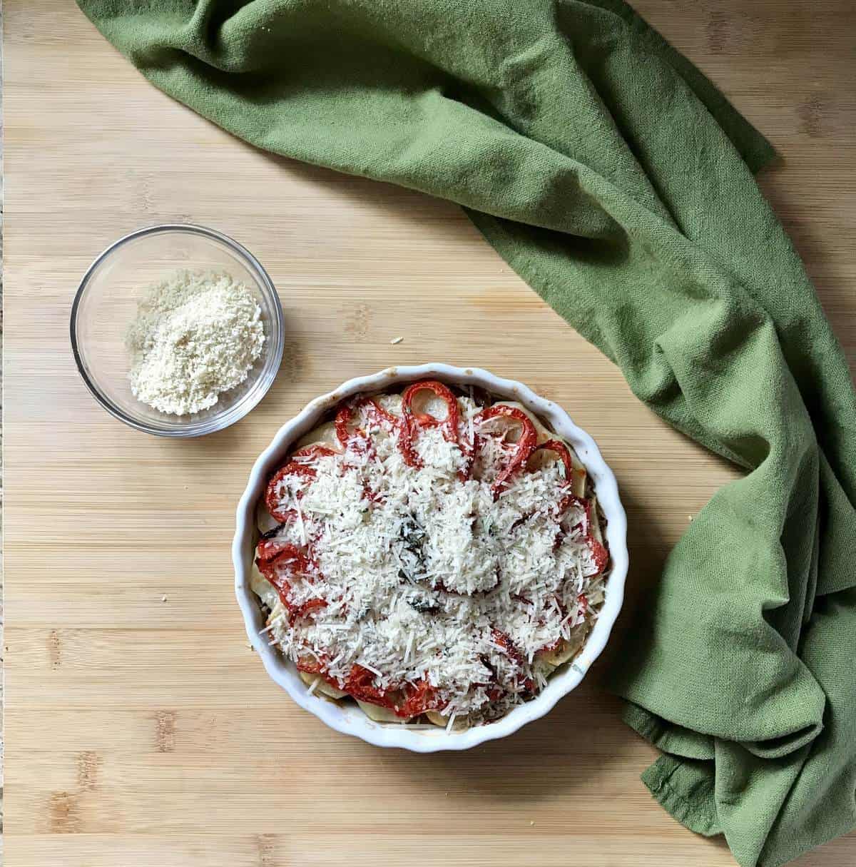 A vegetable casserole dish topped with cheese and panko bread crumbs.