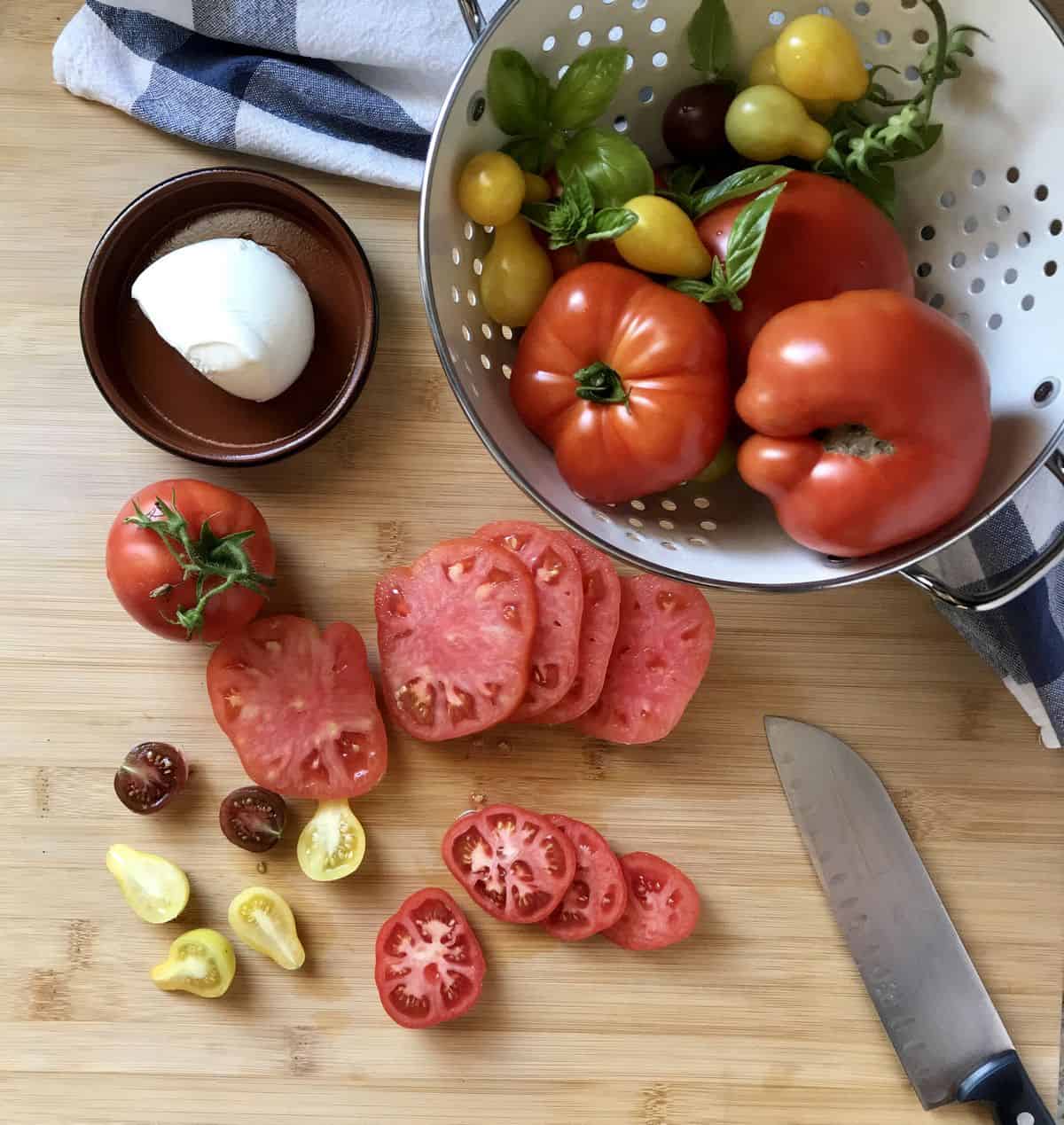 Sliced heirloom tomatoes on a wooden board.