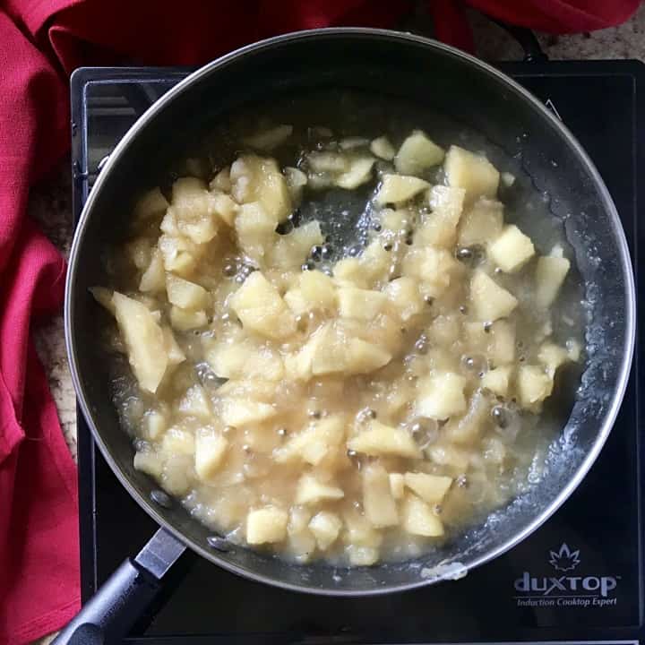 Chunks of softened apples in a sauce pan on their way to becoming apple puree.