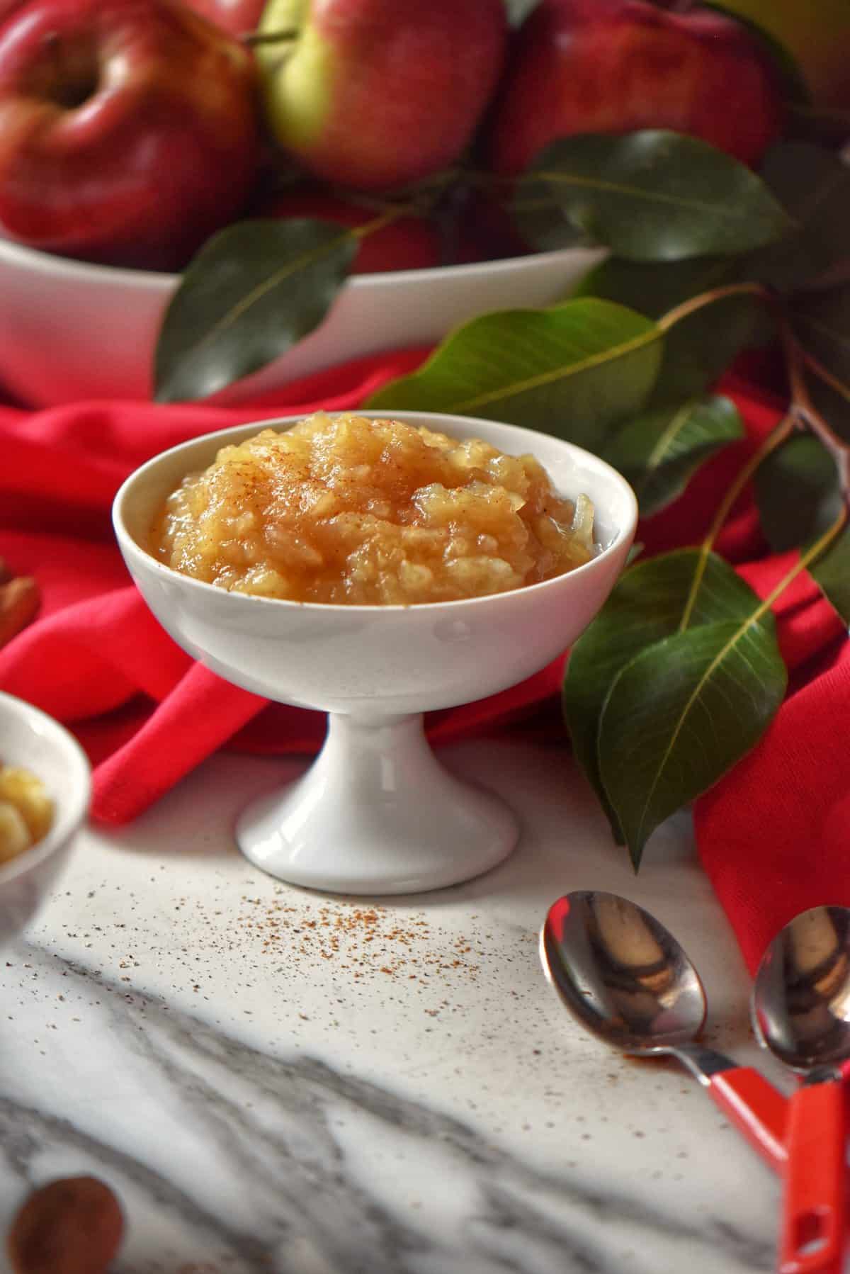 A generous bowl of sugar free applesauce in a white ceramic dish.