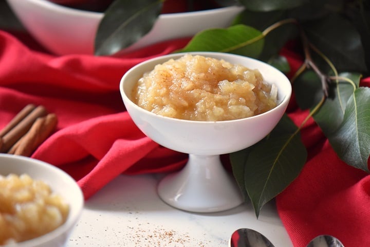 Chunky applesauce in a white ceramic serving dish.